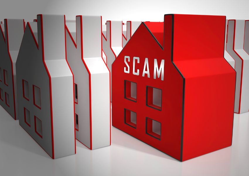 a bunch of house figurines with one in red with the word scam on it